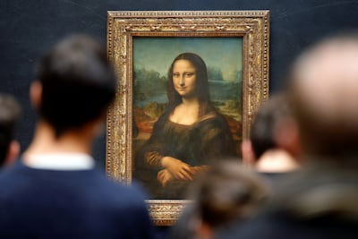 Visitors stand in front of the painting "Mona Lisa" (La Joconde) by Leonardo Da Vinci at the Louvre museum in Paris. Reuters