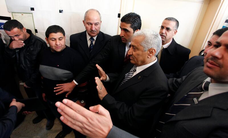 Jordanian Prime Minister Abdullah Ensour, second right, gestures after refusing to skip the voting line, at a polling station, during the first hours of the Jordanian Parliamentary elections, in Al-Salt, Jordan, Wednesday Jan. 23, 2013. Jordan's monarchy has touted Wednesday's parliamentary election as a watershed in the kingdom's democratization. It is the first after last year's constitutional amendments that see King Abdullah II gradually relinquishing much of his powers in running the daily affairs of the state to the legislature, although he will continue — for now — to set broader foreign and security policies. (AP Photo/Mohammad Hannon) *** Local Caption ***  Mideast Jordan Elections.JPEG-09ade.jpg