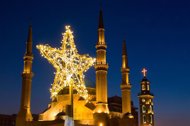 A picture taken with a drone shows the star on top of an illuminated Christmas tree made from protest banners by Lebanese anti-government demonstrators at Martyrs Square in Beirut.  EPA