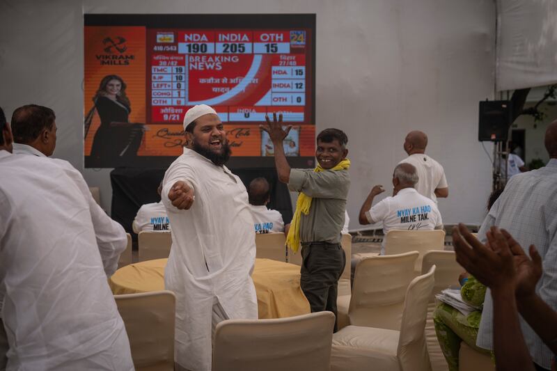Congress party supporters cheer as they watch votes being counted on television at their party headquarters in New Delhi. AP