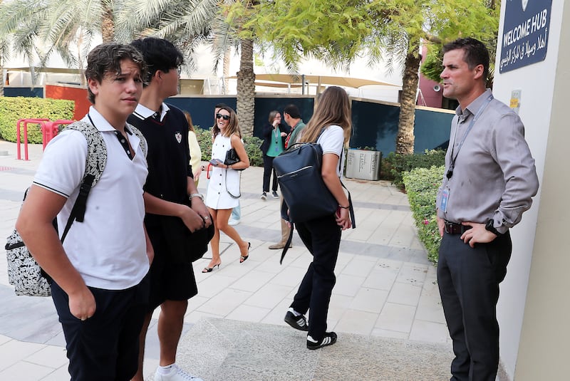 David Hutson, right, head teacher at Dwight School in Dubai, greets returning pupils. Pawan Singh / The National