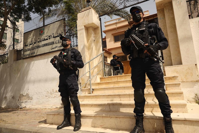 Police officers stand guard outside the Central Elections Commission's office in Gaza City, at the start of the registration period for the May parliamentary election. AFP