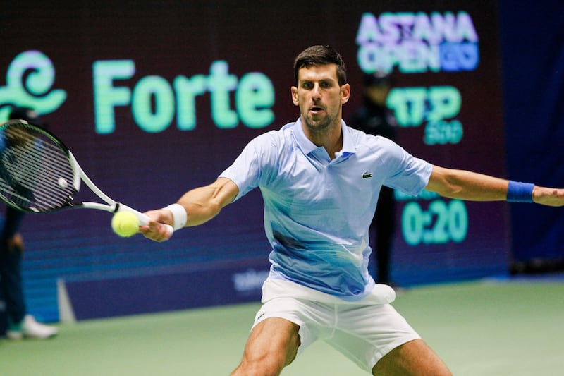 Djokovic returns a ball to Stefanos Tsitsipas. AFP