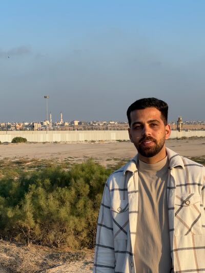 UAE resident and Gazan blogger Noureddin Radwan stands on the Egyptian side of the Rafah border crossing. Behind him are the minarets of the Al Tayba mosque next to his family’s temporary home in Rafah, Gaza. Nada AlTaher / The National