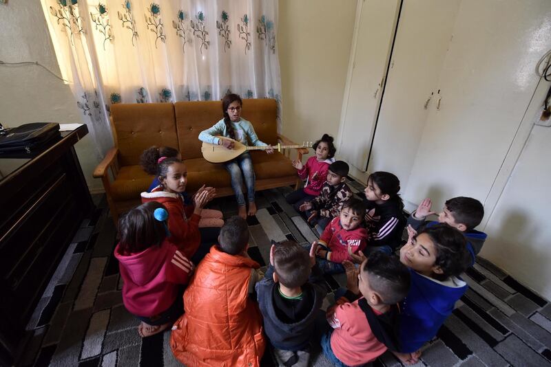 Ten-year-old Syrian Zilan Alaa (centre) plays the Oud while other orphans listen at Child Protection Centre for Orphans Care in Al -Qamishli, the Kurdish region in the Aleppo Governorate in northern Syria. The orphanage houses about 40 children, some who lost their parents during the fighting against ISIS or due the Violent incidents in northern and eastern Syria.  EPA