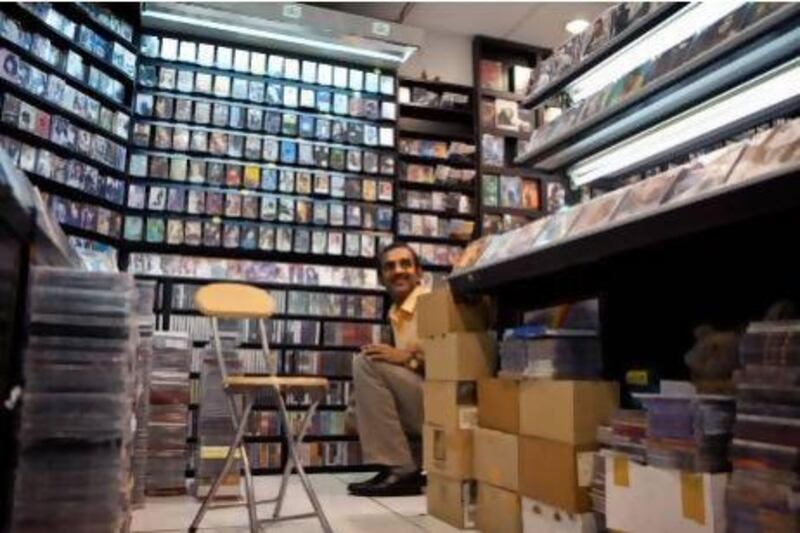 An Indian store salesman organises music cassettes at Kings Recording, a movie and music store in the Hamdan Cenre in downtown Abu Dhabi. Silvia Razgova / The National