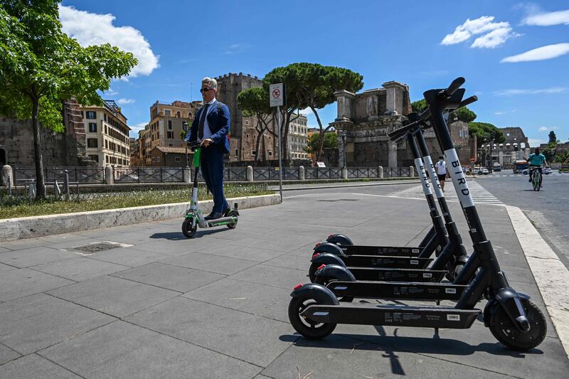 A man rides a shared electric scooter in Rome. AFP