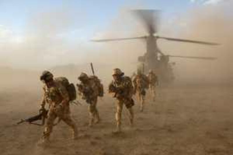 In this image made available by the Ministry of Defence in London, Monday June 8, 2009, British soldiers of the The Black Watch, 3rd Battalion, The Royal Regiment of Scotland, deploy from a Chinook helicopter in the desert of Afghanistan's Upper Sangin Valley, Sunday May 31, 2009, at the start of a joint operation with the Afghan National Army, to search compounds and destroy drug caches and narcotic manufacturing facilities. The operation destroyed ten narcotic manufacturing facilities, and as well as the opium, it netted 220 kg of morphine, more than 100 kg of heroin and 148 kg of cannabis.(AP Photo/Corporal Rupert Frere, Ministry of Defence, ho)  **EDITORIAL USE ONLY**