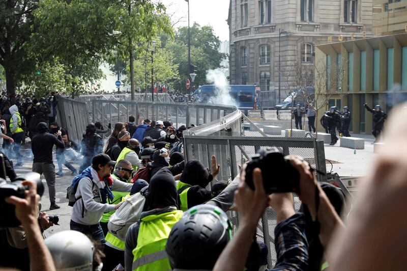 Protesters push on a fence surrounding a police station on the Boulevard de L'Hopital, near the Place d'Italie, on the sidelines of the annual May Day rally in Paris. AFP