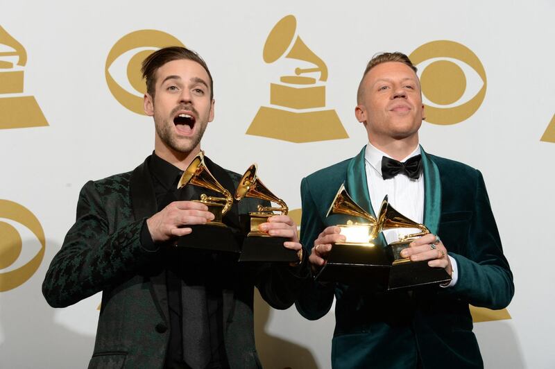 Macklemore (R) and Ryan Lewis pose with their awards in the press room during the 56th Grammy Awards at the Staples Center in Los Angeles on January 26, 2014.    AFP PHOTO/Joe KLAMAR (Photo by JOE KLAMAR / AFP)