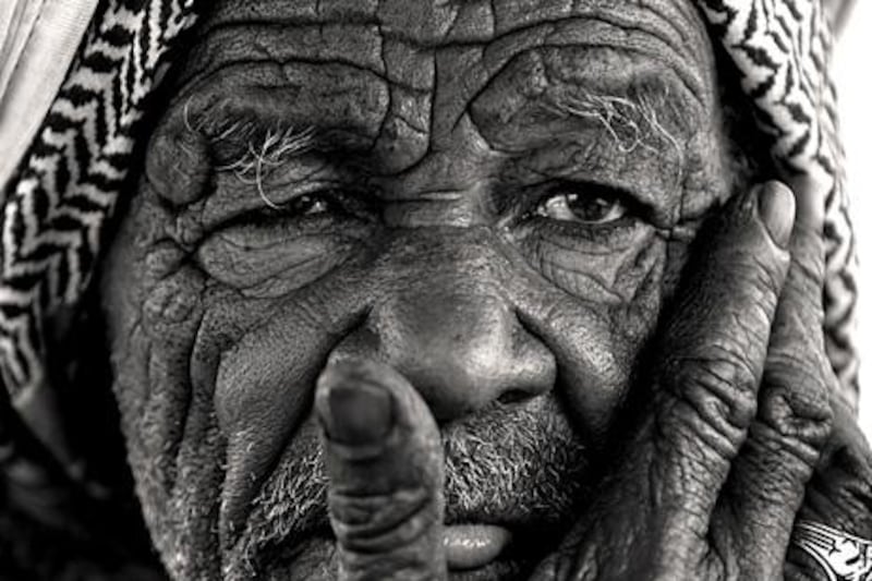 Nasser Haji Malek originally photographed the man touching his face in colour, but felt it worked better in black and white.