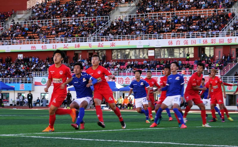 This photo taken on September 24, 2017 shows players of Lhasa Chengtou (in blue) and Zibo Sunday (in red) competing for the ball during their 2017 Chinese Football Association Amateur League football match at the People's Cultural and Sports Center, located at a height of 3,658 metres (12,000 feet) above sea level, in Lhasa in China's western Tibet Autonomous Region.
There will be mid-game oxygen breaks but no team will fancy a trip to sky-high Lhasa Chengtou next season after they made history in becoming the first Tibetan side to reach China's professional league. / AFP PHOTO / STR / China OUT / TO GO WITH AFP STORY FBL-ASIA-CHN-TIBET-MINORITIES,FOCUS BY PETER STEBBINGS