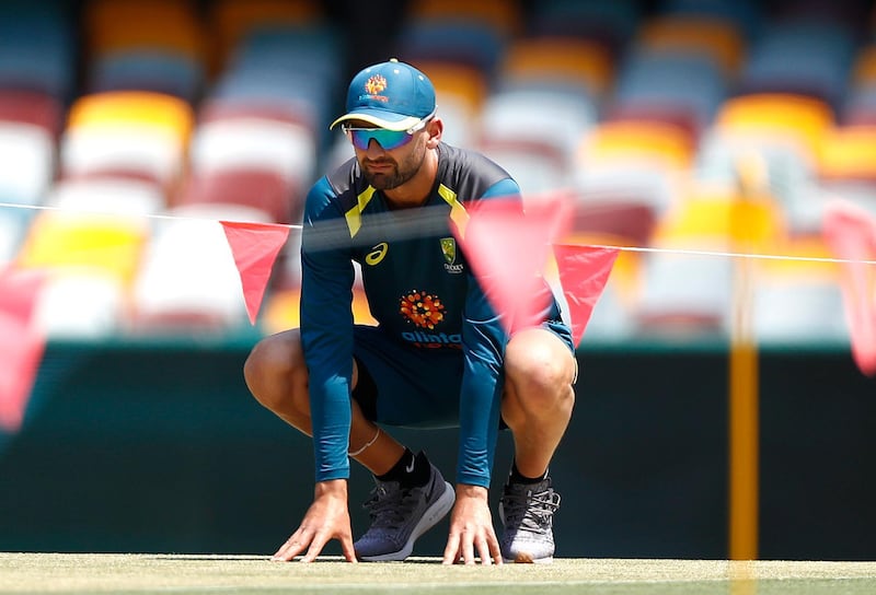 Australia spinner Nathan Lyon inspects the pitch at the Gabba. Getty