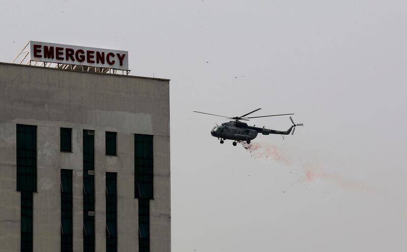 An Indian Air Force helicopter showers flower petals at the Safdarjung hospital in New Delhi. AP Photo