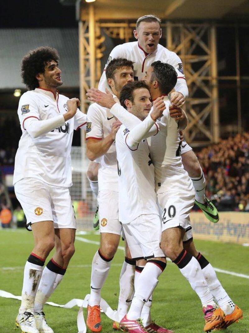 Manchester United players celebrate Robin Van Persie's goal against Crystal Palace during their English Premier League soccer match at Selhurst Park in London February 22, 2014. REUTERS/Paul Hackett