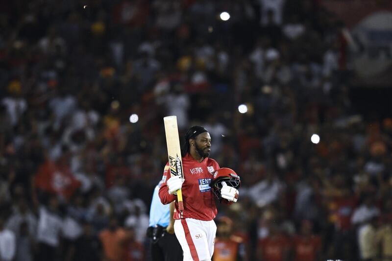 Kings XI Punjab cricketer Chris Gayle celebrates his century (100 runs) during the 2018 Indian Premier League (IPL) Twenty20 cricket match between Kings XI Punjab and Sunrisers Hyderabad at The Punjab Cricket Association Stadium in Mohali on April 19, 2018.  / AFP PHOTO / CHANDAN KHANNA / ----IMAGE RESTRICTED TO EDITORIAL USE - STRICTLY NO COMMERCIAL USE----- / GETTYOUT