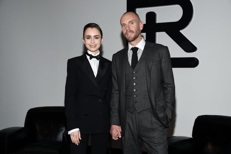 Lily Collins, left, and her husband, Charlie McDowell, attend the Ralph Lauren Fall/Winter 2022 fashion show at the Museum of Modern Art in New York. AP