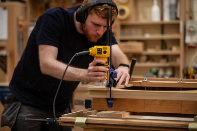 An employee works on the production of jukeboxes at Sound Leisure. Interest in these machines has increased over the past few years. Photo: Sound Leisure