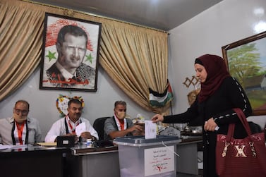 A Syrian woman casts her ballot at a polling station in the Nubl neighbourhood of Aleppo on July 19. AFP