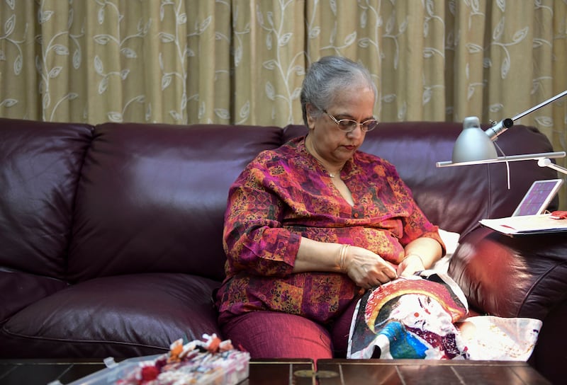 Varma cross stitching in the comfort of her home, but she has also cross stitched while travelling on long-haul flights 
