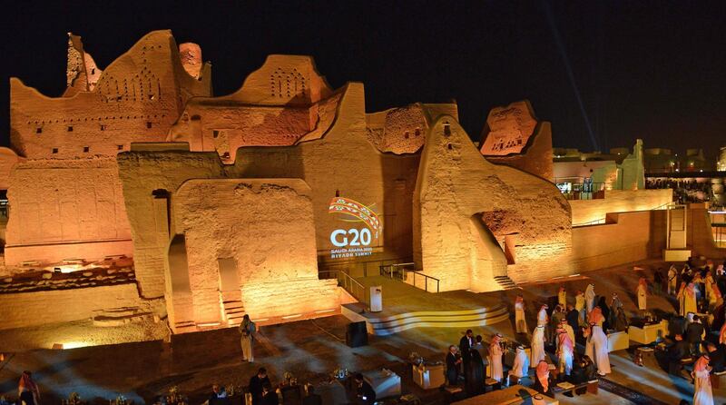 The G20 logo is projected at the historic site of al-Tarif in Diriyah district, on the outskirts of Saudi capital Riyadh. Saudi Arabia hosts the G20 summit on November 21 in a first for an Arab nation, with the downsized virtual forum dominated by efforts to tackle a resurgent coronavirus pandemic and crippling economic crisis.  AFP