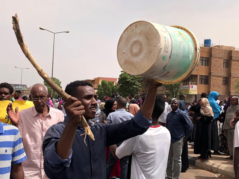 A Sudanese protester bangs on a bucket during a demonstration against the military council, in Khartoum, Sudan, on Sunday, June 30, 2019. AP Photo