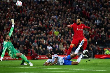 LIVERPOOL, ENGLAND - APRIL 19: Mohamed Salah of Liverpool scores their side's fourth goal whilst under pressure from Aaron Wan-Bissaka of Manchester United during the Premier League match between Liverpool and Manchester United at Anfield on April 19, 2022 in Liverpool, England.  (Photo by Clive Brunskill / Getty Images)