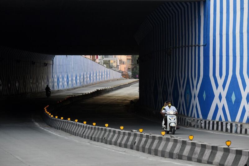 Motorists ride along a deserted road during the government-imposed nationwide lockdown against the spread of coronavirus, in Bangalore.  AFP