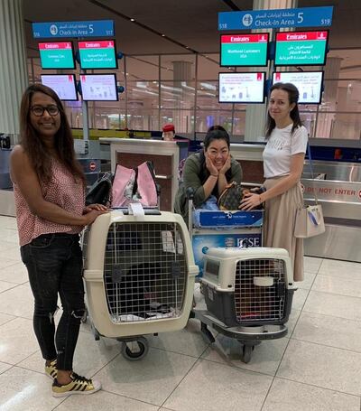 Evelyn Lau of ‘The National’, centre, volunteers as a flight buddy