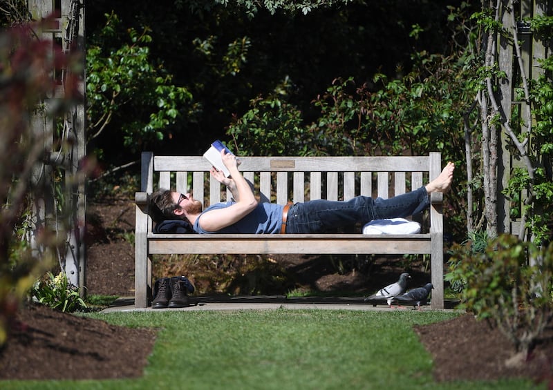 A man puts his feet up and relaxes in Regent's Park, London. EPA