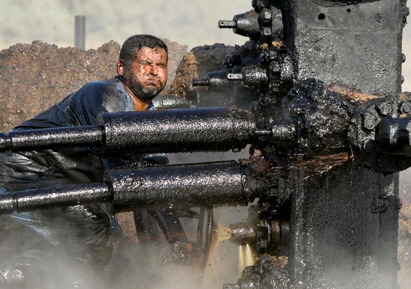 An Iraqi worker fixes the pump at an oil well in Bob Al-Sham, some 25 km east from Baghdad, September 23, 2004. Saboteurs on Thursday blew up the oil installation in Bob Al-Sham, oil officials said. Further information was not immediately available. REUTERS/Ceerwan Aziz Pictures of the Month September 2004  OP/ABP - RP5DRICFDFAA