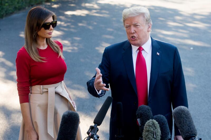epa06877706 US President Donald J. Trump (R) delivers remarks to members of the news media beside First Lady Melania Trump (L) before departing the South Lawn of White House by Marine One, in Washington, DC, USA, 10 July 2018. Trump departs for a week-long trip to Europe; during which time he is expected to visit the United Kingdom, attend the NATO summit in Brussels and meet with President of Russia Vladimir Putin in Helsinki.  EPA/MICHAEL REYNOLDS