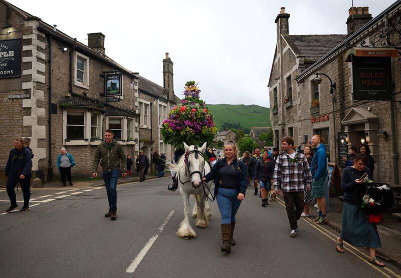 The Garland King is paraded through the town, a long-running annual tradition in Castleton, central England. Reuters