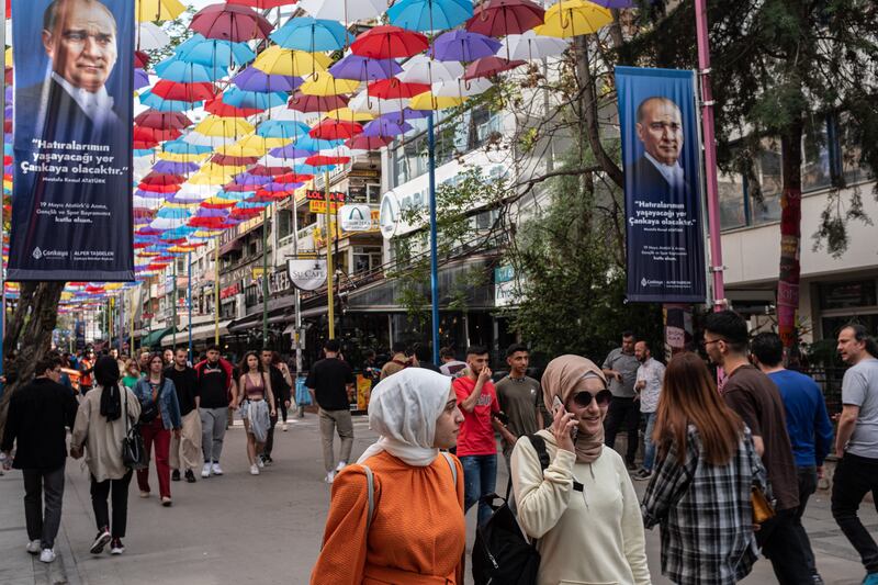 People walk under posters showing Mustafa Kemal Ataturk, founder of modern Turkey, in Ankara. The country is holding its first presidential run-off election after neither candidate earned more than 50 per cent of the vote in the May 14 election. Getty