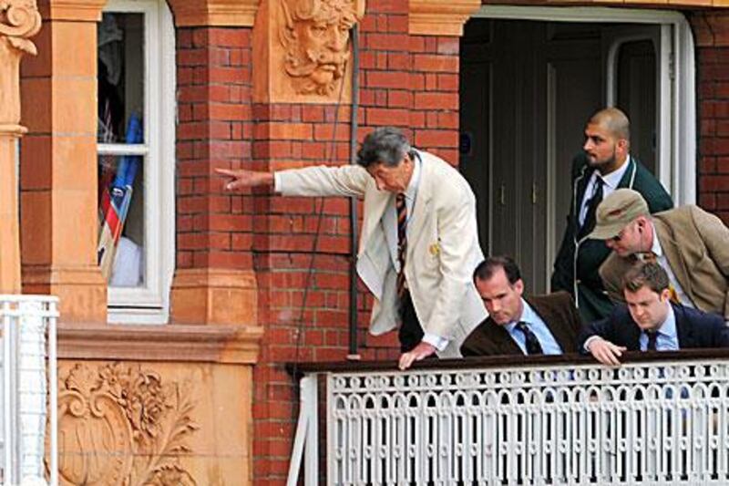 MCC members inspect a broken window after Matt Prior returned to the dressing room.