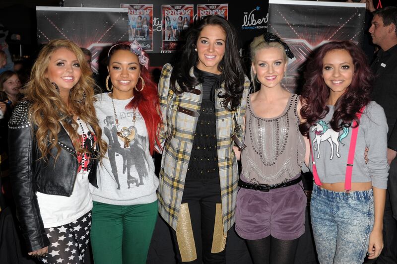 Jesy Nelson, in star leggings, a white T-shirt and leather jacket, with her Little Mix bandmates at an 'X Factor' concert in London on December 5, 2011