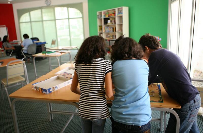 Children staying at the shelter work on a jigsaw puzzle in a classroom at the Dubai Foundation for Women and Children. The majority of the foundation’s clients are female, and 50 per cent are Emiratis. Nicole Hill / The National