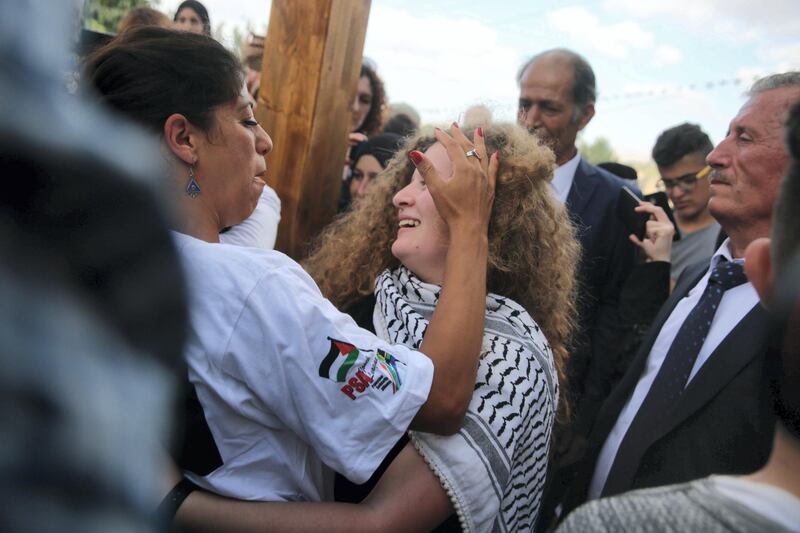 Ahed is welcomed home by friends and family.