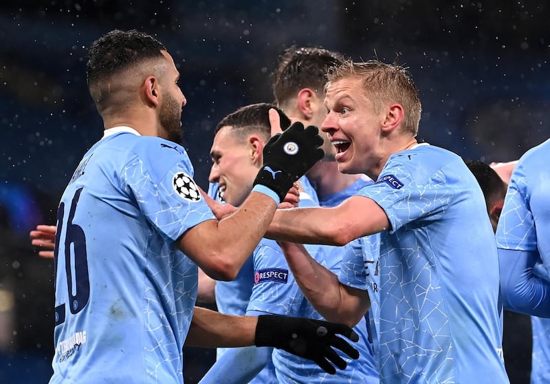 MANCHESTER, ENGLAND - MAY 04: Riyad Mahrez of Manchester City celebrates with Oleksandr Zinchenko after scoring his team's second goal during the UEFA Champions League Semi Final Second Leg match between Manchester City and Paris Saint-Germain at Etihad Stadium on May 04, 2021 in Manchester, England. Sporting stadiums around the UK remain under strict restrictions due to the Coronavirus Pandemic as Government social distancing laws prohibit fans inside venues resulting in games being played behind closed doors. (Photo by Laurence Griffiths/Getty Images)