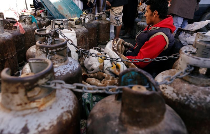 A man sits next to cooking gas cylinders as he waits outside a gas filling station amid a scarcity in cooking gas supplies in Sanaa, Yemen. Khaled Abdullah / Reuters