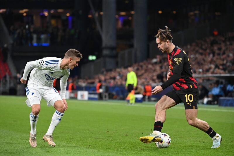 FC Copenhagen defender Elias Jelert shepherds Manchester City's Jack Grealish. AFP