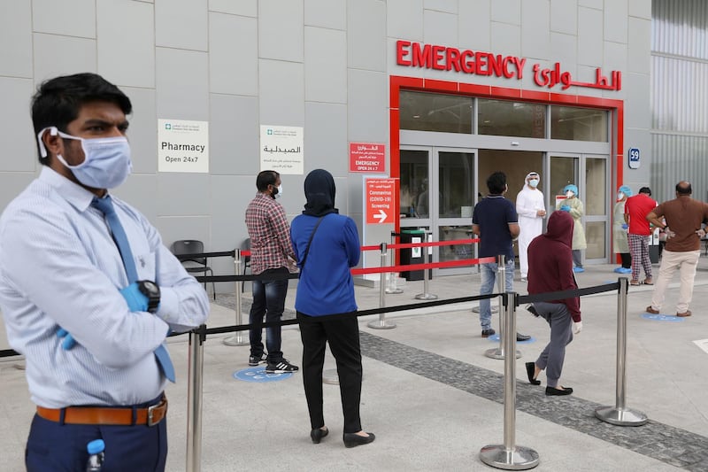 People wearing protective face masks wait to be tested, amid the coronavirus disease (COVID-19) outbreak, at the Cleveland Clinic hospital in Abu Dhabi, United Arab Emirates, April 20, 2020. Picture taken April 20, 2020. REUTERS/Christopher Pike
