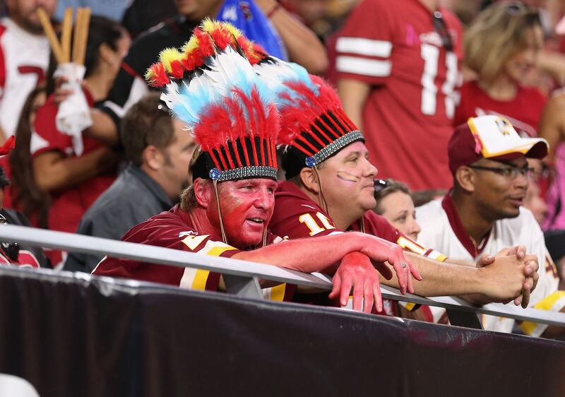 Fans watch the second half of the NFL game against the Arizona Cardinals in Glendale, Arizona. The NFL's Washington Football Team, which dropped the controversial nickname "Redskins" last year, said it will ban spectators from wearing Native American ceremonial head gear or face paint at home games.  Getty / AFP