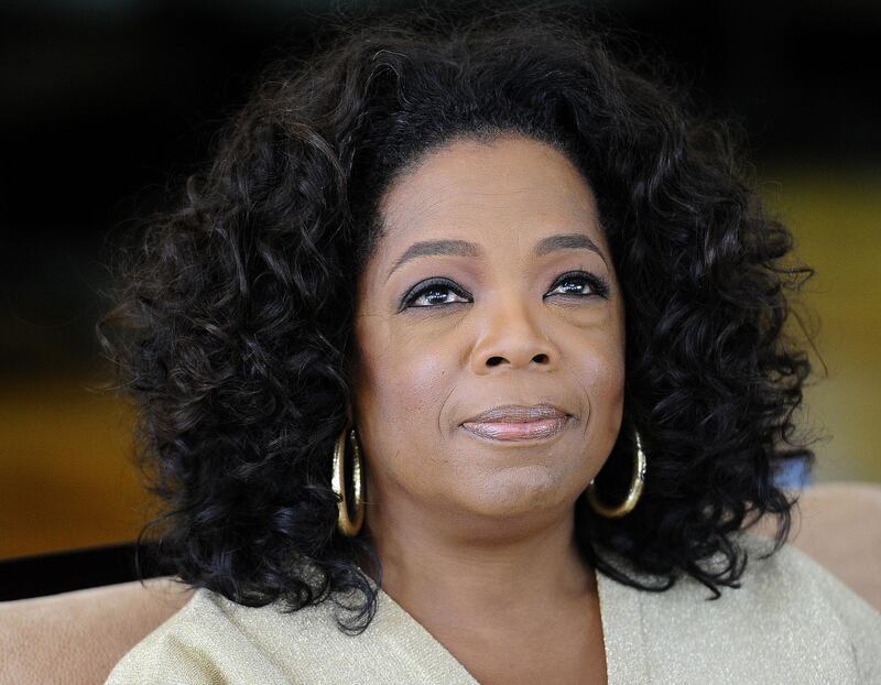 (FILES) In this file photo taken on January 13, 2012 US talk show queen Oprah Winfrey looks on as she answers to journalist's questions at her South African girls' academy on January 13, 2012 in Henley on Klip.  Television personality Oprah Winfrey has agreed to produce shows for Apple as the iPhone maker prepares to make a push into original content. / AFP / STEPHANE DE SAKUTIN
