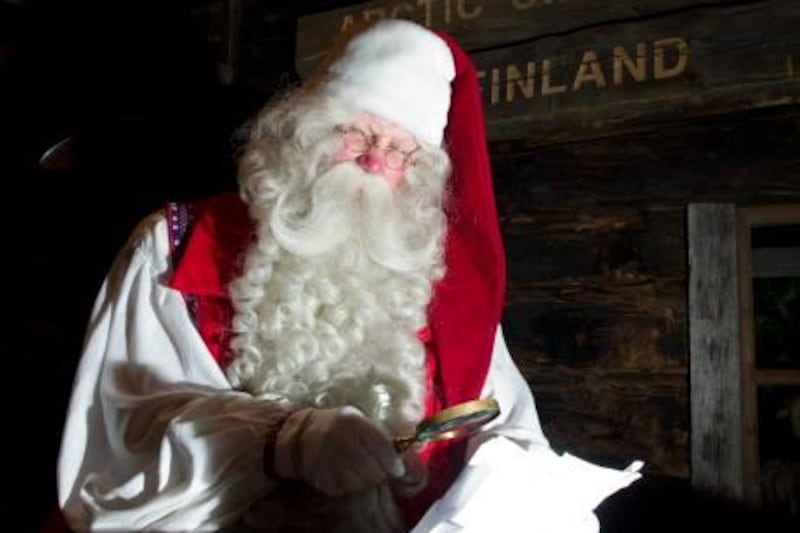 Santa Claus reads letters at his desk in his office in the Santa Park near Rovaniemi, Finnish Lapland, on December 14, 2011.          AFP PHOTO/JONATHAN NACKSTRAND