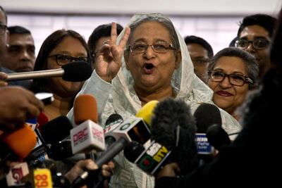 Bangladesh Prime Minister Sheikh Hasina flashes a victory sign as she speaks to the media persons after casting her vote in Dhaka, Bangladesh, Sunday, Dec. 30, 2018. Voting began Sunday in Bangladesh's contentious parliamentary elections, seen as a referendum on what critics call Prime Minister Sheikh Hasina's increasingly authoritarian rule. (AP Photo/Anupam Nath)