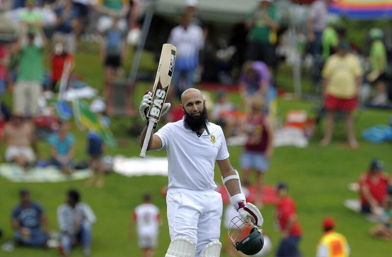 South Africa captain Hashim Amla raises his bat as he celebrates scoring a double century during the second day of the first Test against and the West Indies at Supersport Park in Centurion on December 18, 2014. Gianluigi Guercia / AFP