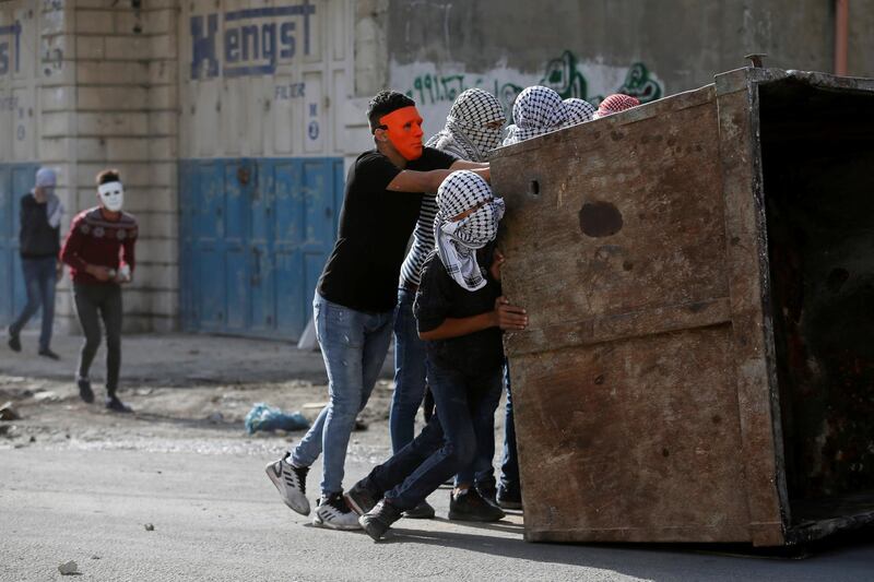 Palestinian demonstrators set up a barricade during an anti-Israel protest in al-Arroub refugee camp, in the Israeli-occupied West Bank. Reuters