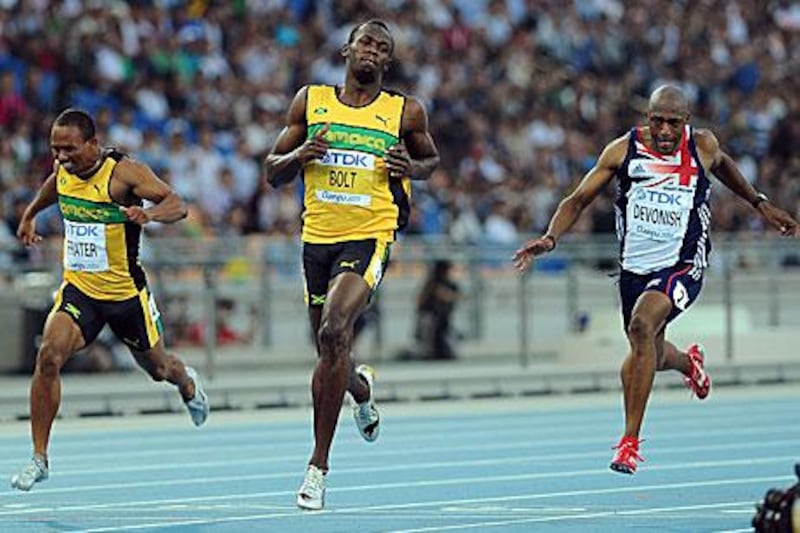 Usain Bolt, centre, looks fresh as he wins his 100m semi-final heat in 10.05secs at the world championships in Daegu.