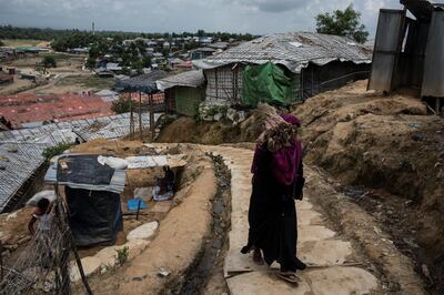 A Rohingya woman carries wood in a refugee camp near Cox's Bazar, Bangladesh, August 11 2018. Campbell MacDiarmid for The National